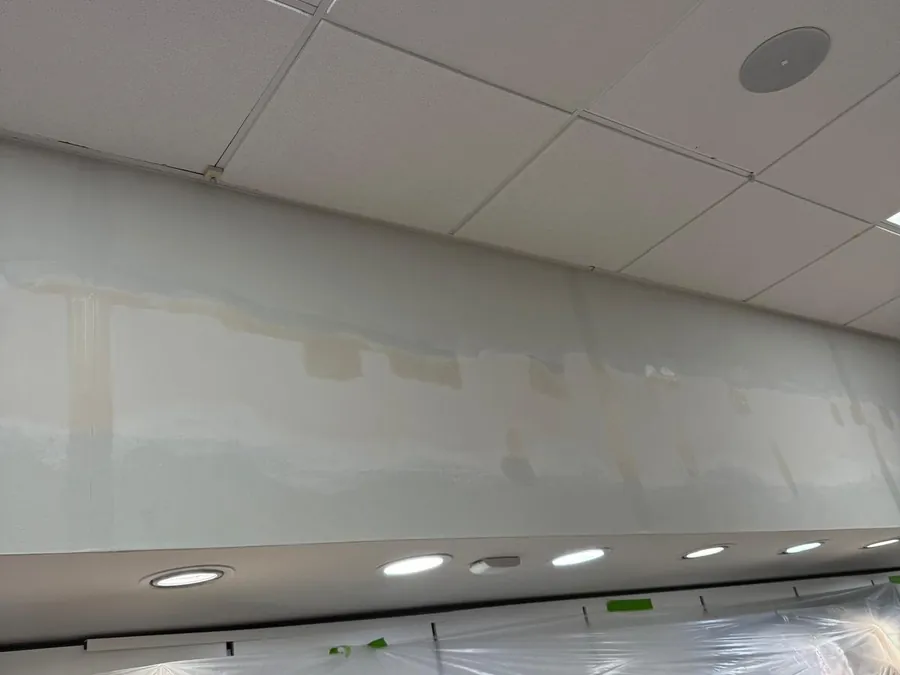 Commercial wall filled and made good below a suspended ceiling, ready for priming